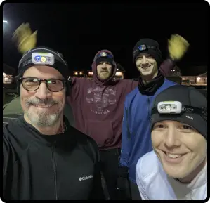 men at night with headlamps